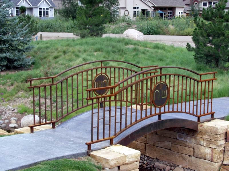 Charles Seha Professional Landscape Designer in Rochester, Minnesota -  Stone and Wood Bridge design for Homes and Businesses